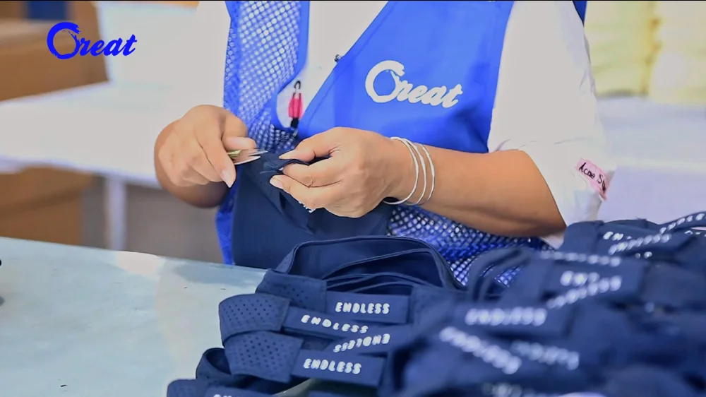 Final inspection and packaging -- finished caps being checked and packed with custom hang tags and retail packaging
